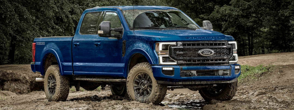 2017–2024 Ford F-250 Super Duty with front bumper and brush guard on dirt road
