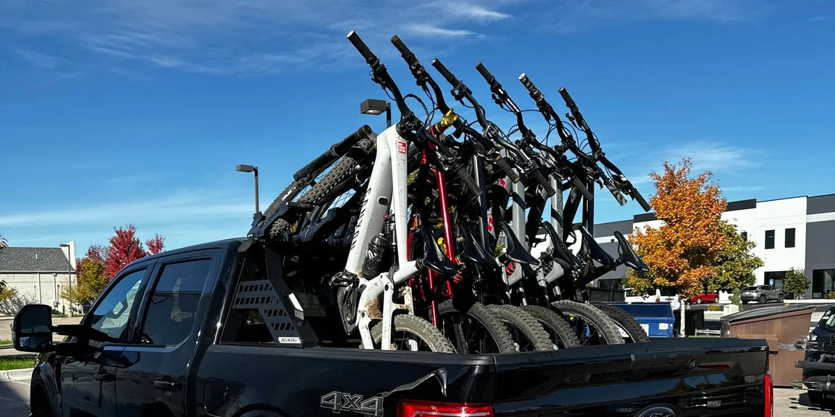 Black pickup truck carrying five mountain bikes on a Big Days Chase Rack