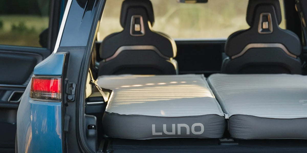 Luno AIR+FOAM Pro mattress inflated in the cargo area of a Rivian R1S with the rear hatch open