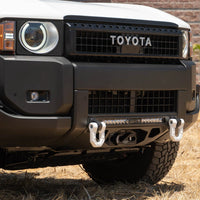 Close-up of a Toyota vehicle's front bumper with a blurred background