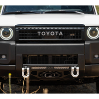 Front view of a white Toyota vehicle with a black grille and bumper.