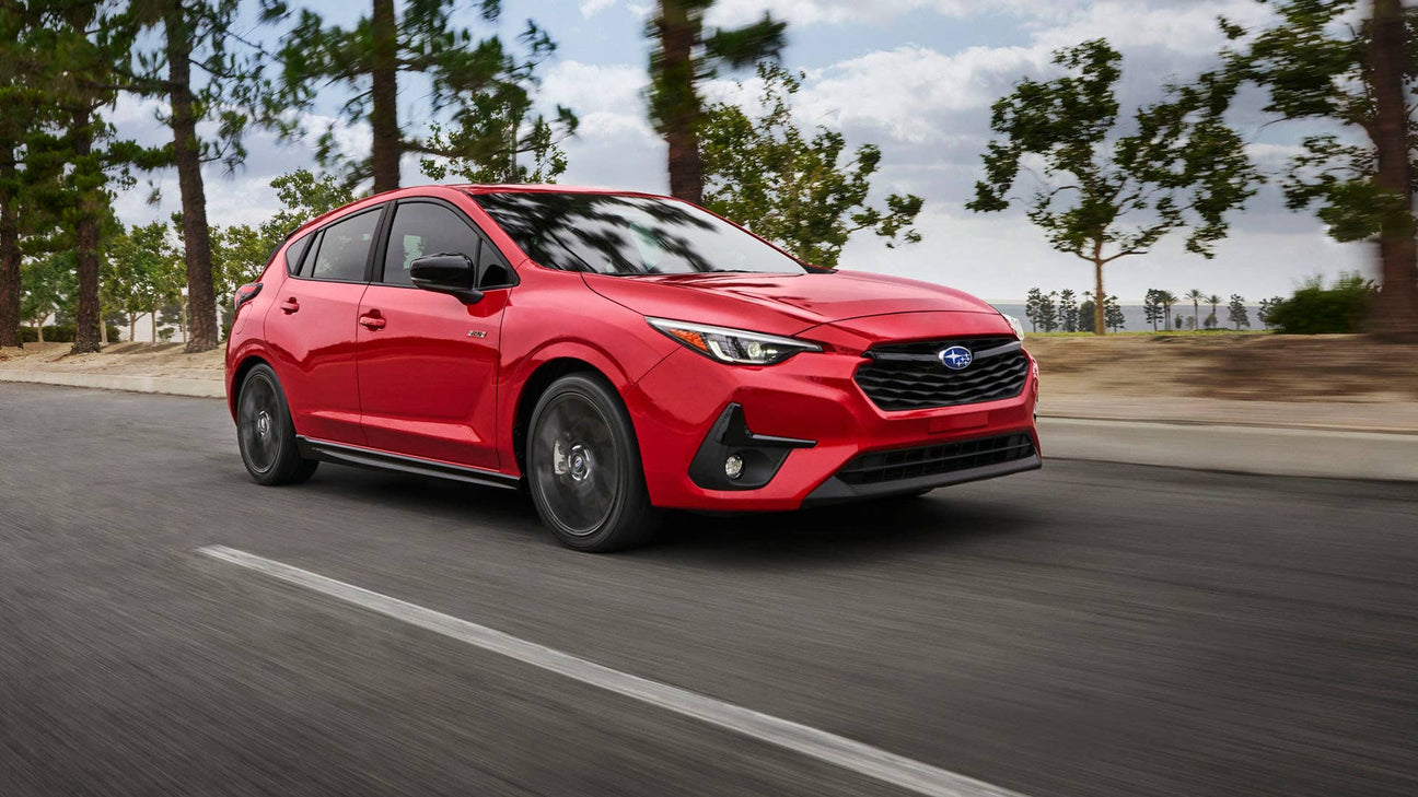2024 Red Subaru Impreza on a mountain road