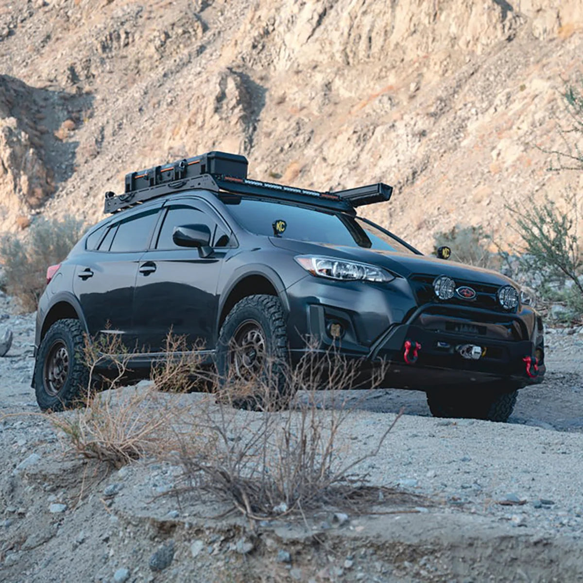 Subaru Crosstrek with a Body Armor 4x4 front winch bumper and roof rack on a desert trail