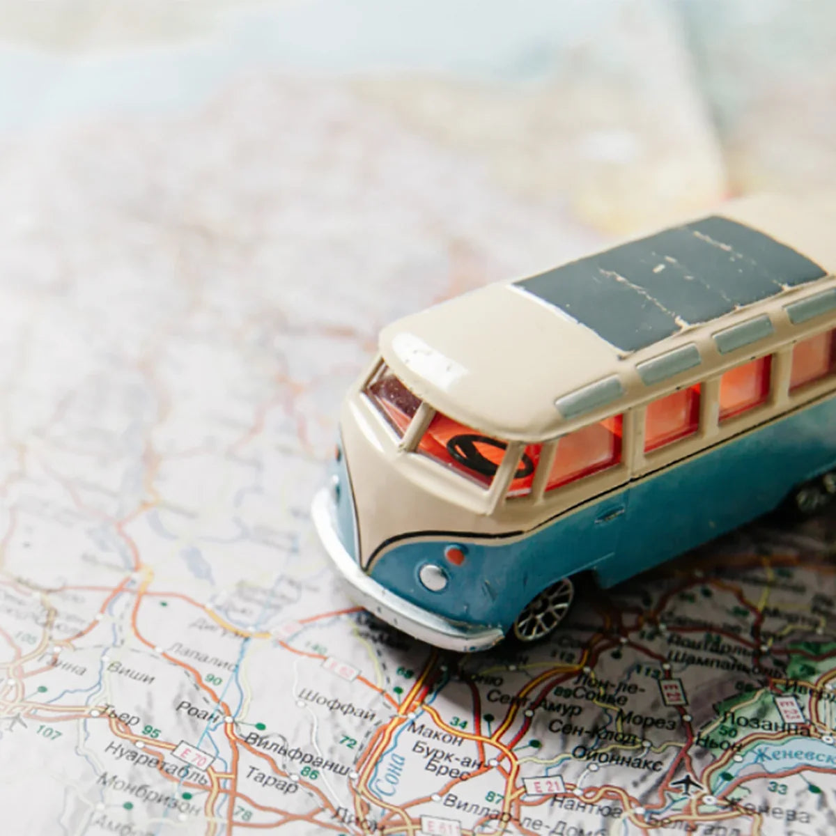 Toy camper van resting on a paper road map
