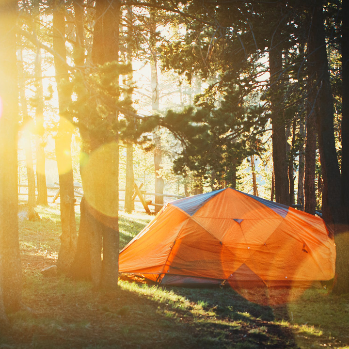 3-person tent in the woods at sunset