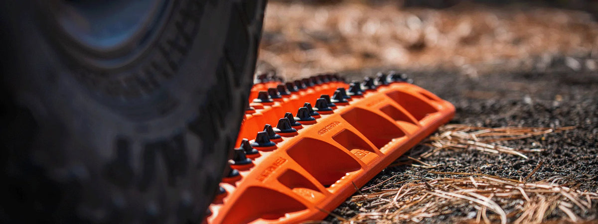 Recovery boards under truck tires in sand