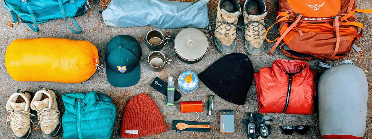 Curated camping gear including cookware, sleeping bags, and outdoor equipment