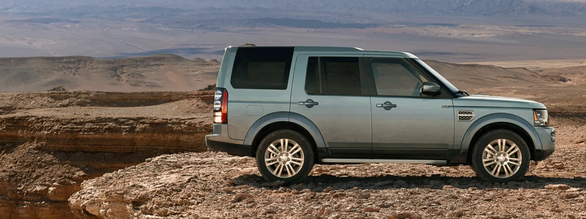 Land Rover LR4 with expedition roof rack basket loaded on mountain off-road trail