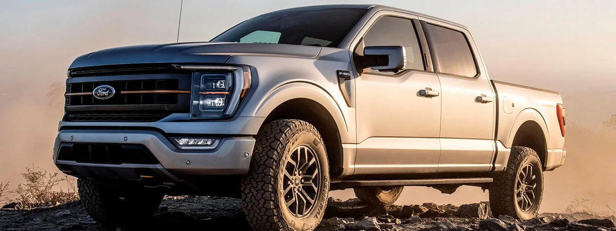 Ford F-150 with rooftop tent and bed rack loaded for an overland trip