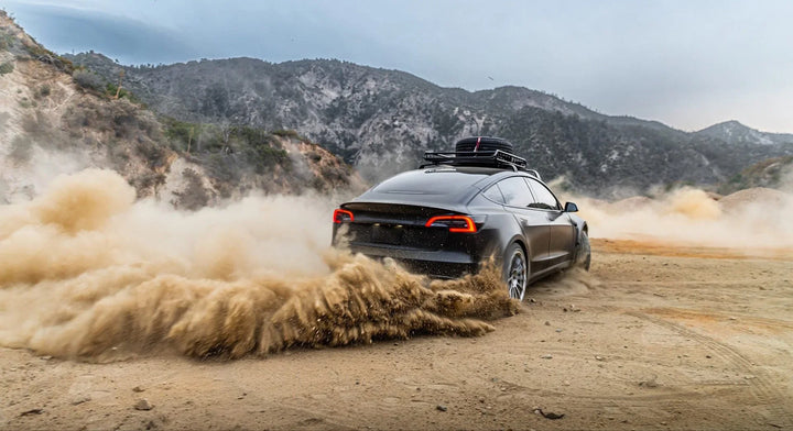 Black Tesla Model 3 in the dirt