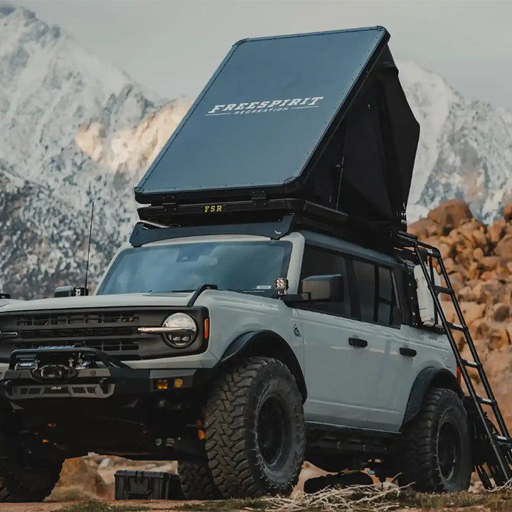 Ford Bronco with Free Spirit Aspen Pro rooftop tent open in a mountain campsite