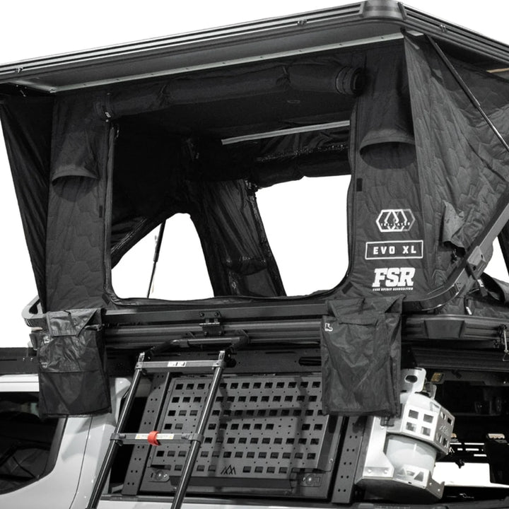 Free Spirit Evolution XL rooftop tent deployed on an overland truck overlooking a desert canyon