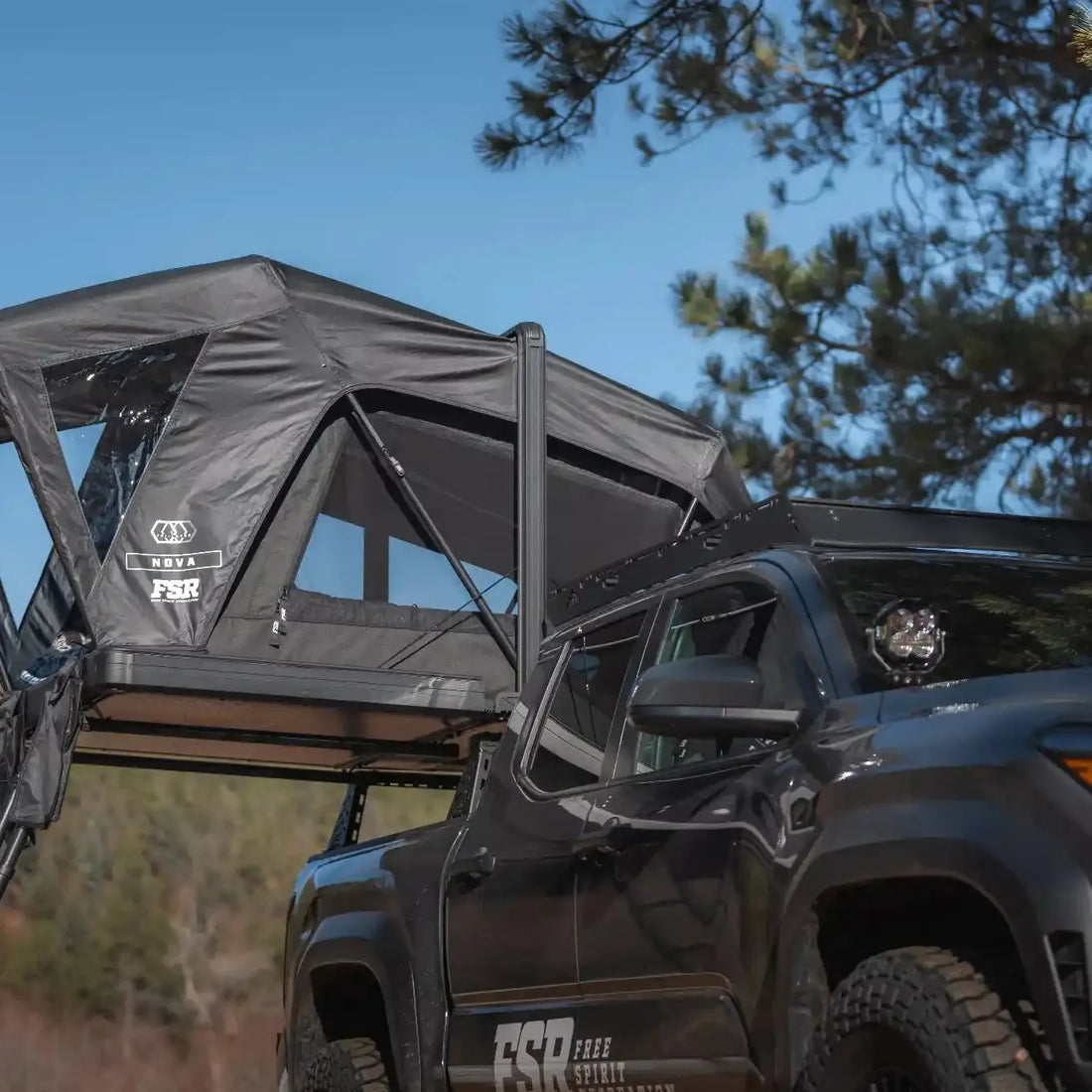 Free Spirit Nova Standard rooftop tent open on a truck at camp