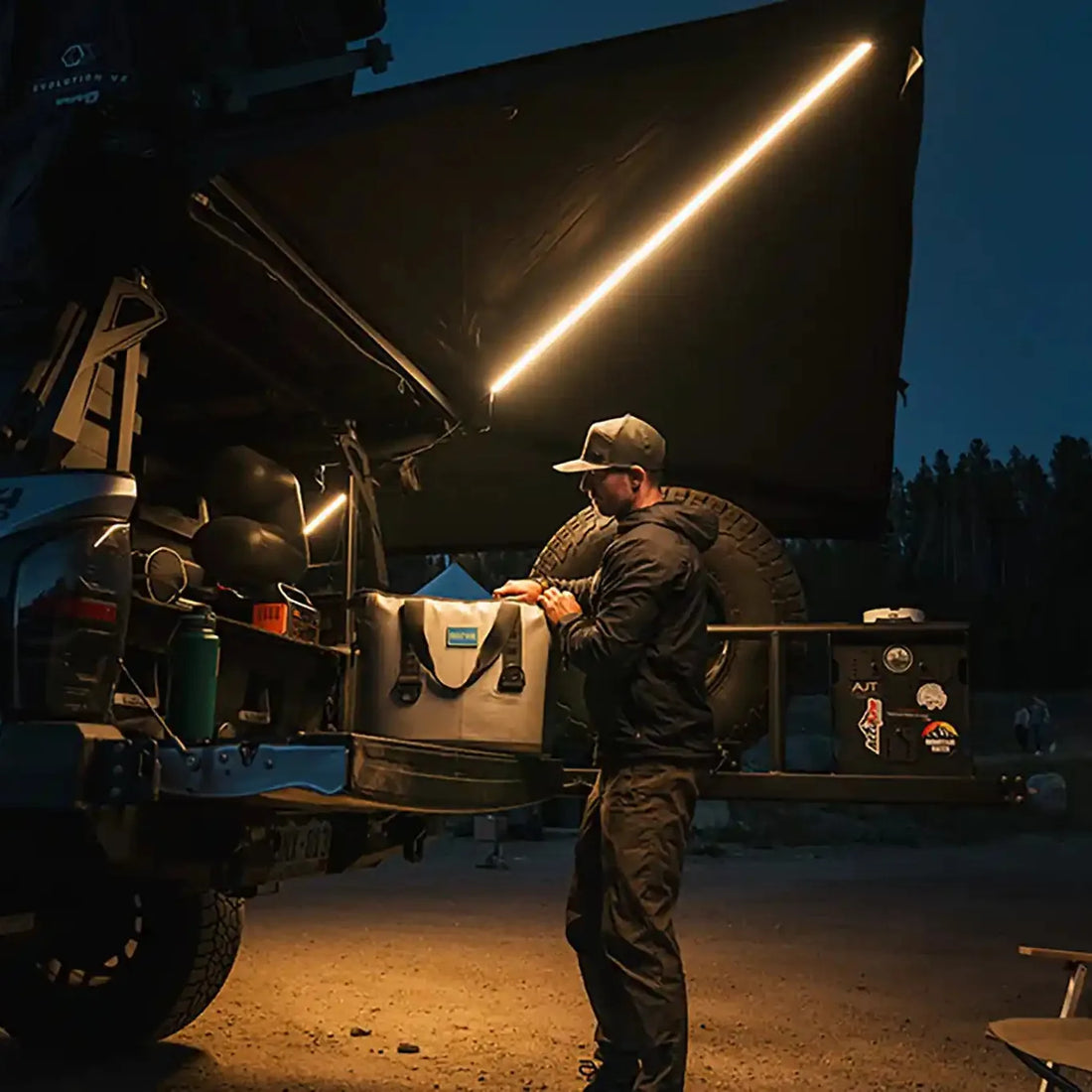 Camper under a Free Spirit 270 Awning V2 with LED lights on a Tacoma