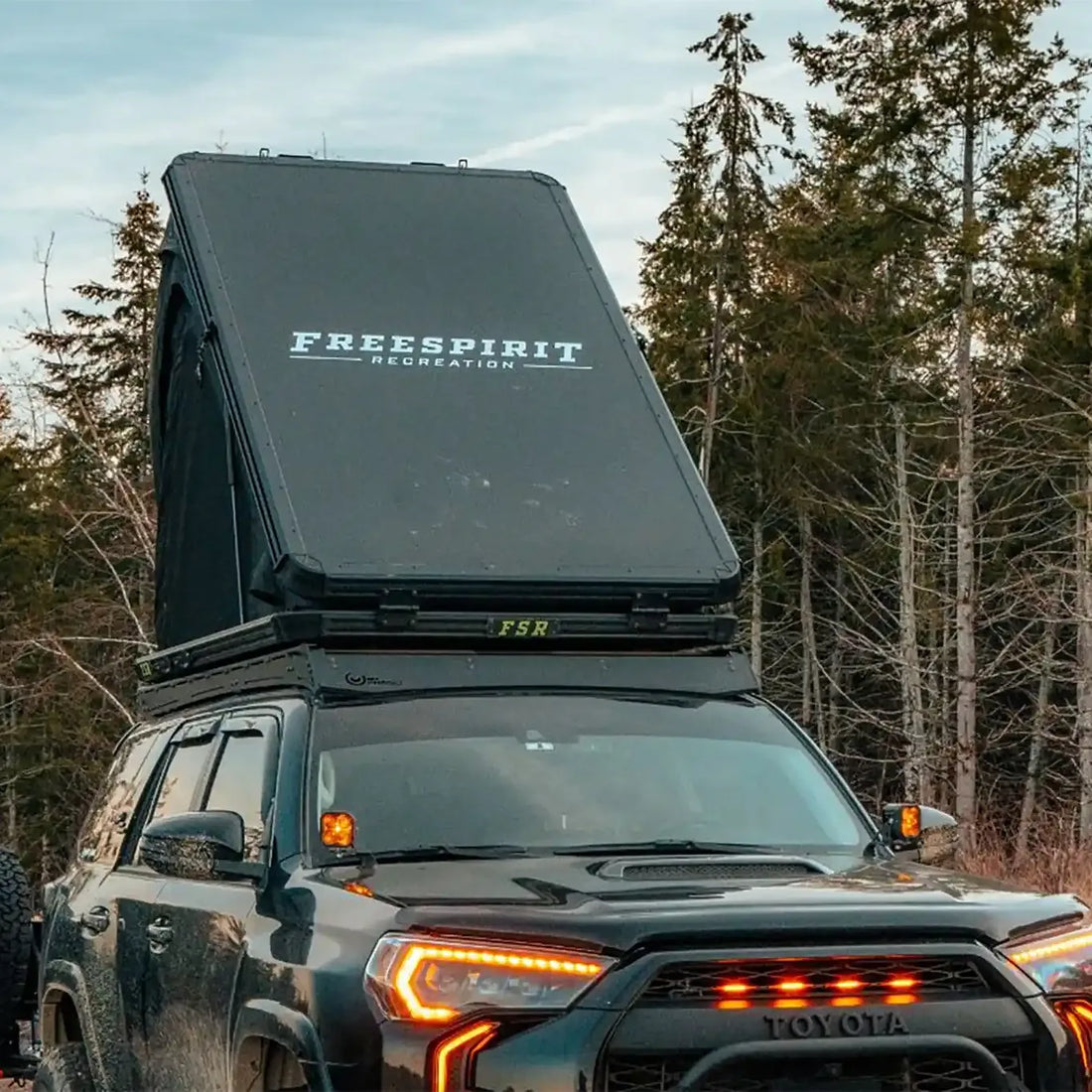 Toyota 4Runner with Free Spirit Aspen Pro rooftop tent set up in the woods