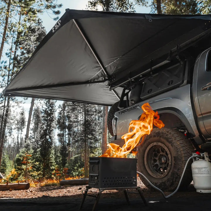 Camper under a Free Spirit 270 Awning V2 with LED lights on a Tacoma