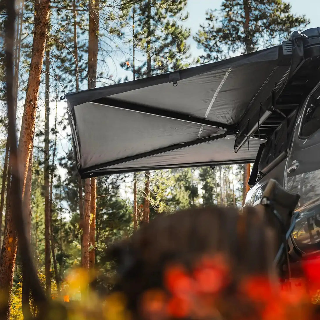 Free Spirit 270 Awning V2 wraparound shade on a Tacoma in the woods