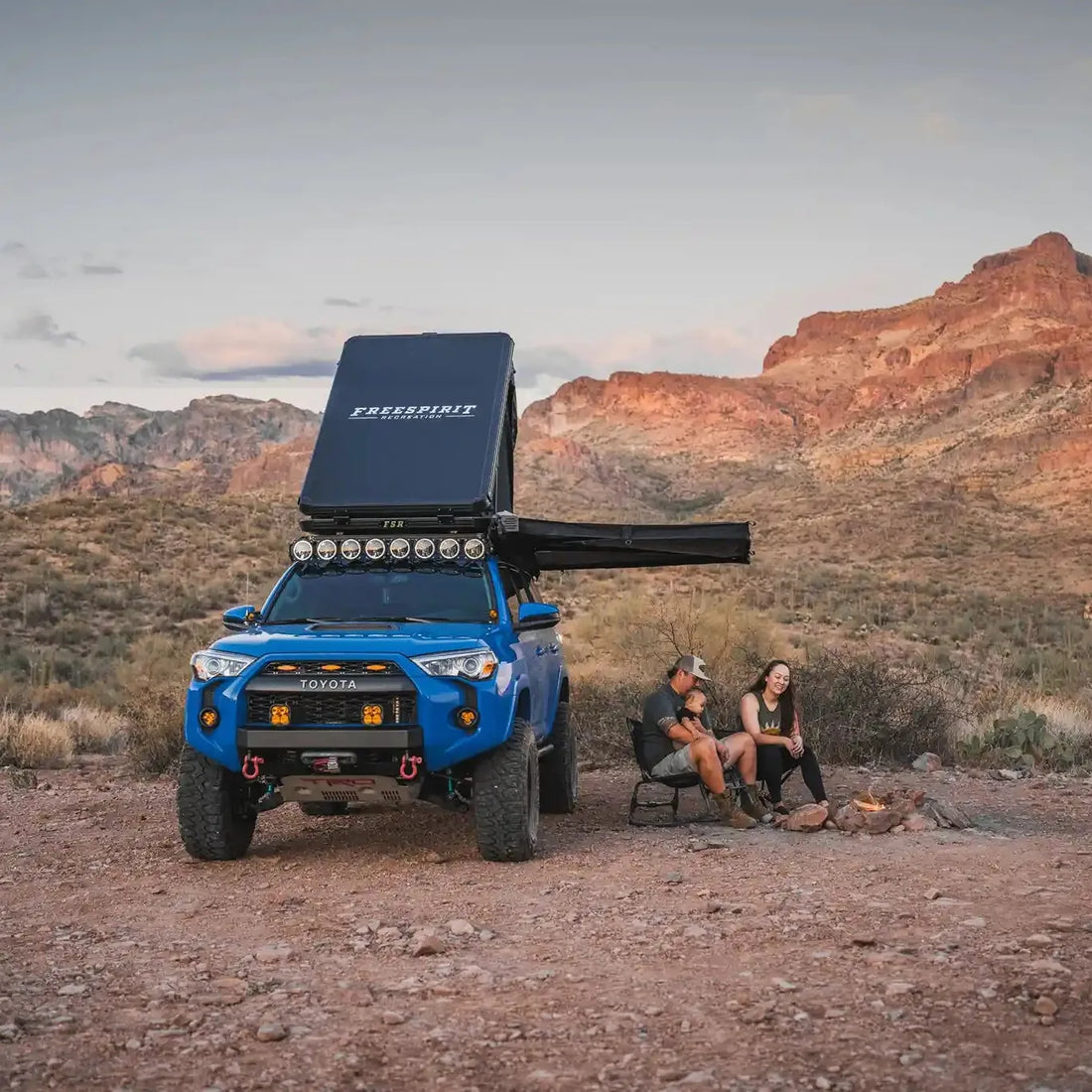 Blue 4Runner with Free Spirit Aspen Pro rooftop tent and awning at a desert camp