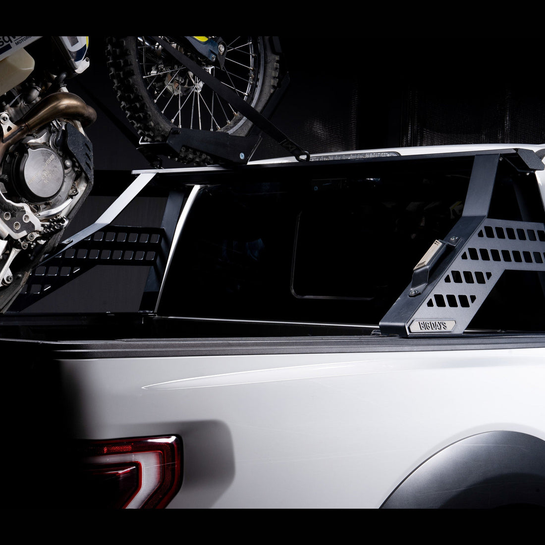 Pickup hauling dirt bikes in-bed on a Big Days Chase Rack with tailgate up
