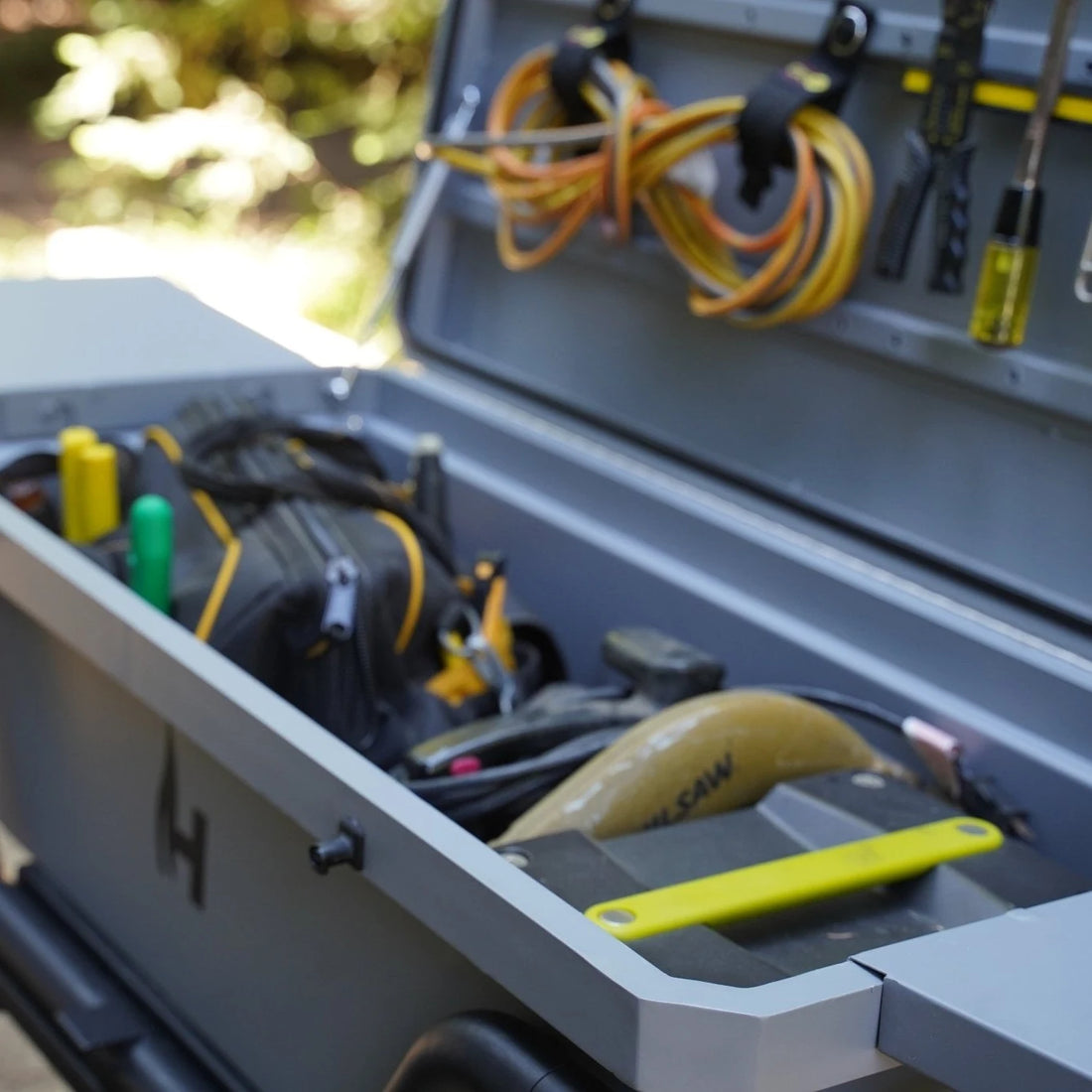 Toolbox with tools and equipment on a blurred outdoor background