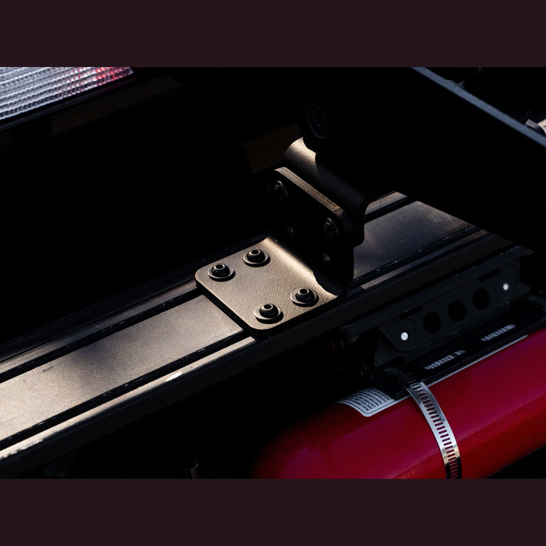 Moto offset kit installed on Chase Rack T-track under a dirt bike mount