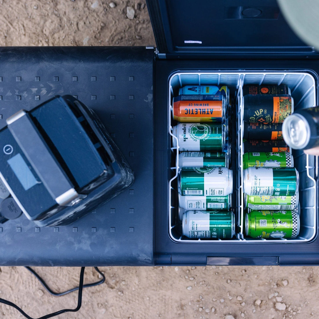 Outdoor portable fridge with assorted cans for camping and overlanding