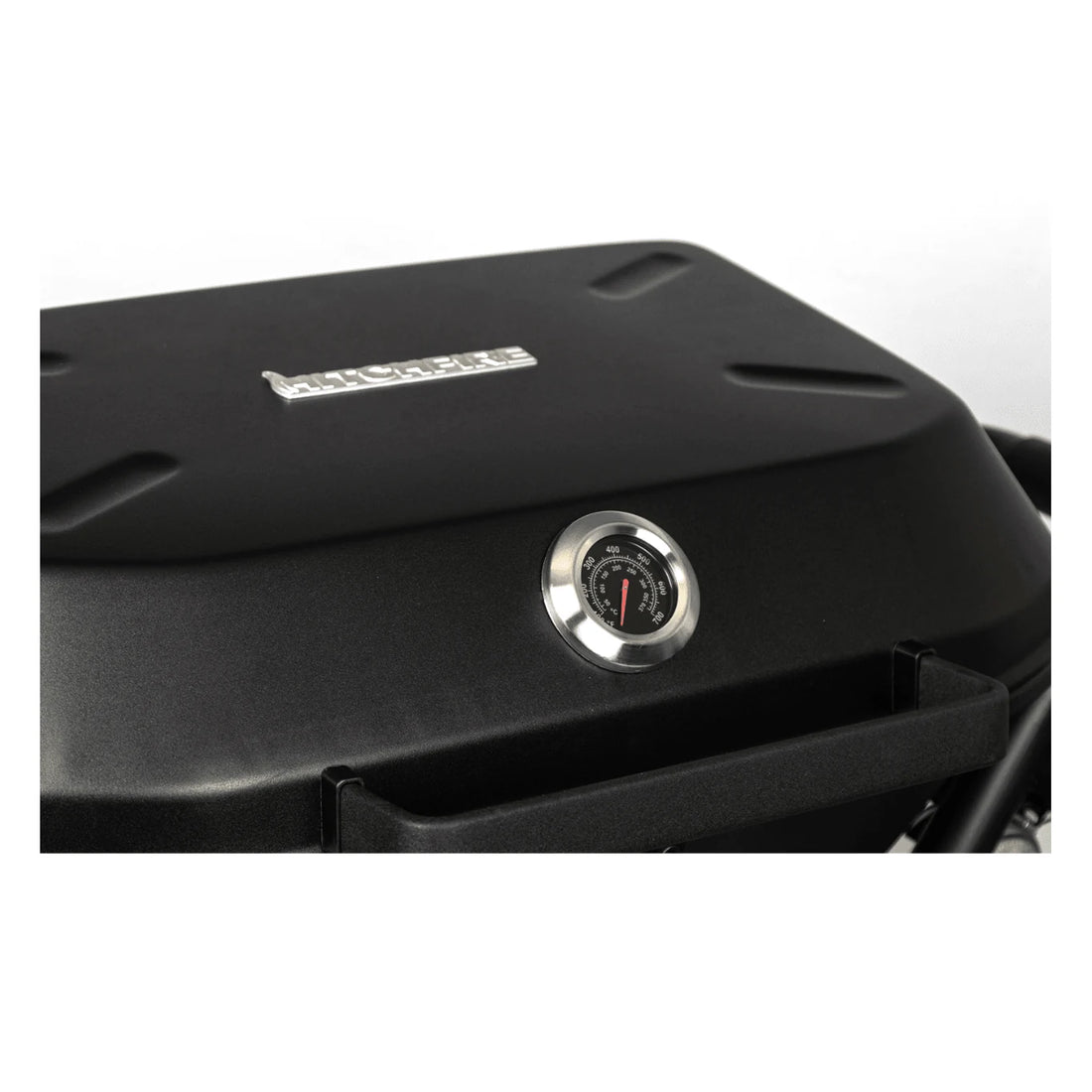 Black barbecue grill with a temperature gauge on a white background