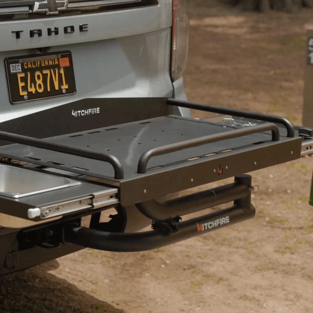 Truck bed with an extended grill and sink setup on a natural background