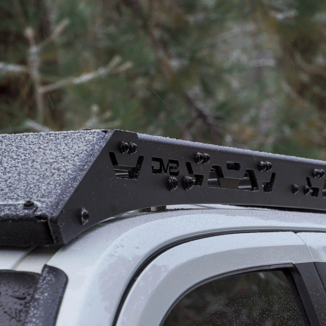 Roof rack system on a vehicle with a forest background