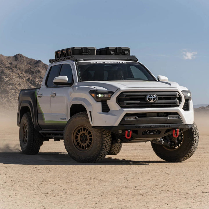 Toyota truck in a desert landscape with mountains in the background