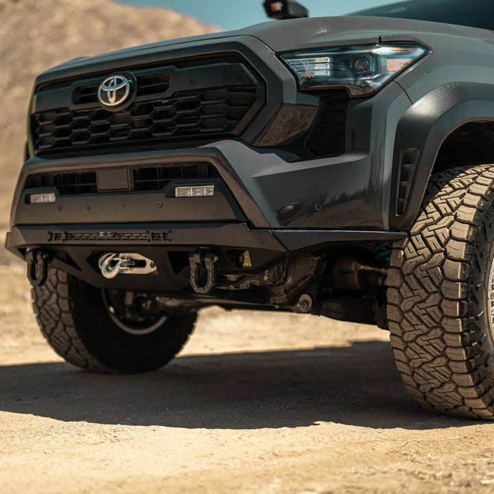 Toyota truck with off-road tires on a dirt road