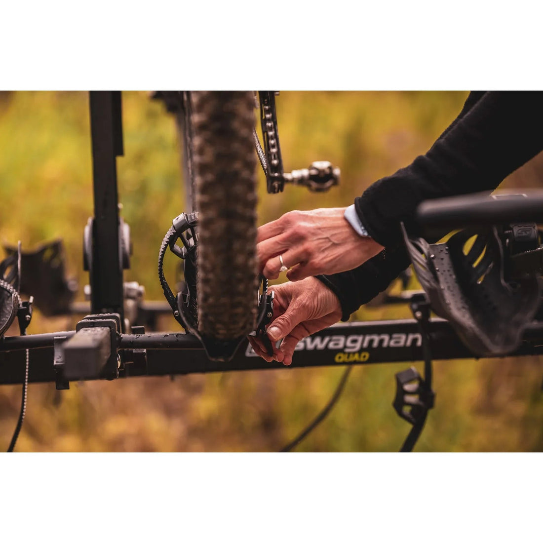 Swagman Quad 2+2 hitch mounted bike rack loaded behind a vehicle