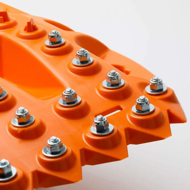 Close-up of metal teeth on orange ActionTrax extreme recovery boards