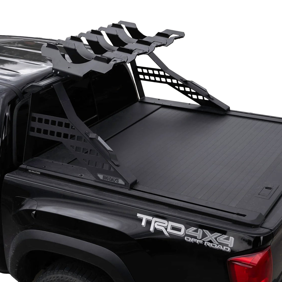 Black truck bed with a tonneau cover and roof rack on a white background
