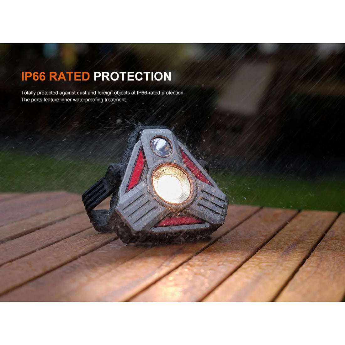 Fenix CP50R camping lantern IP66 rated, shown in rain on a wooden deck
