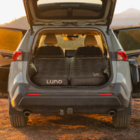 Car trunk with LUNO sleeping pad in a desert setting