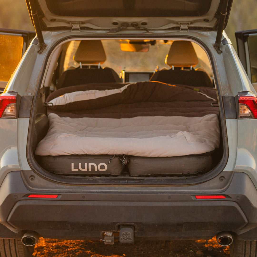 Inflatable bed in the trunk of a car with &