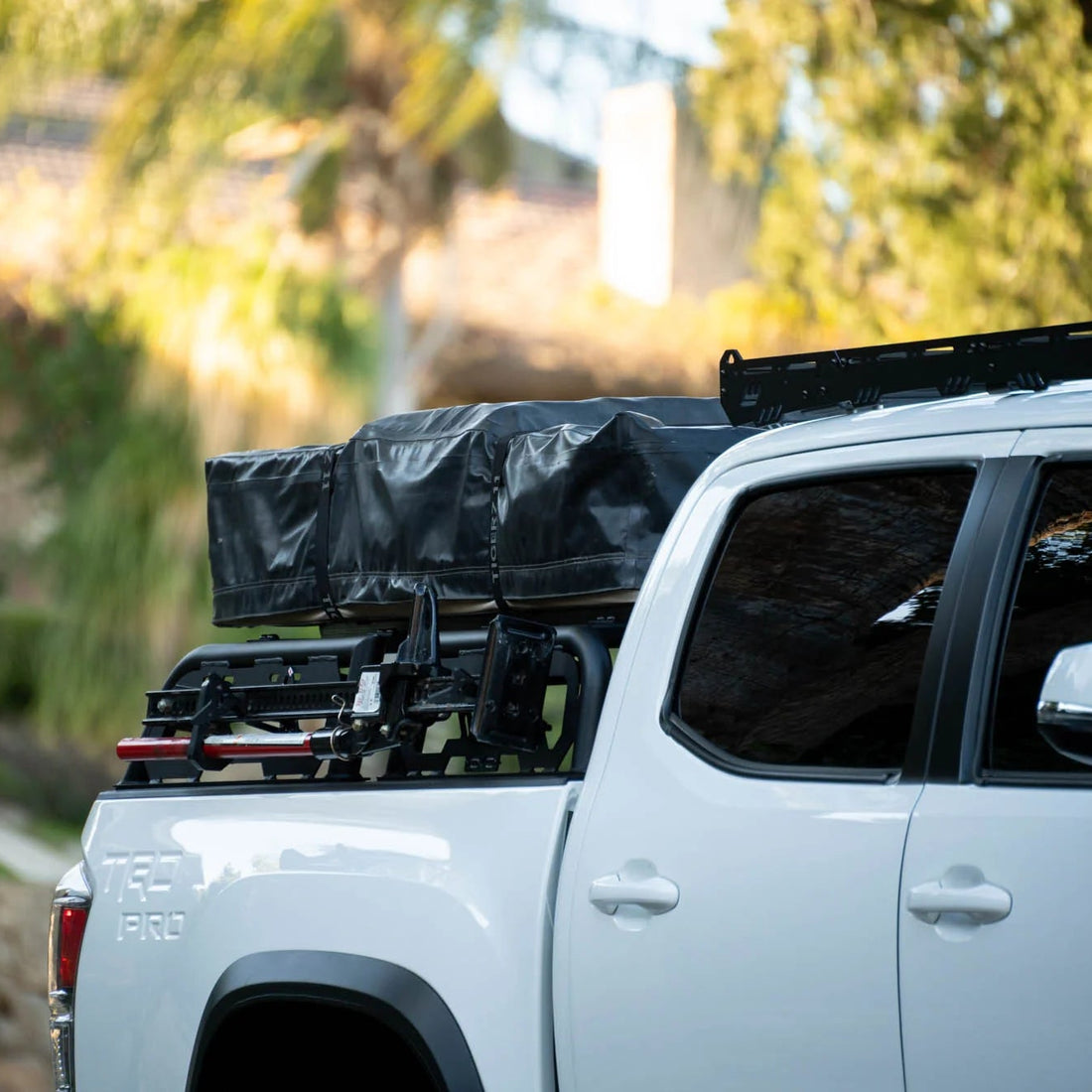 White truck with roof rack and cover in a residential area