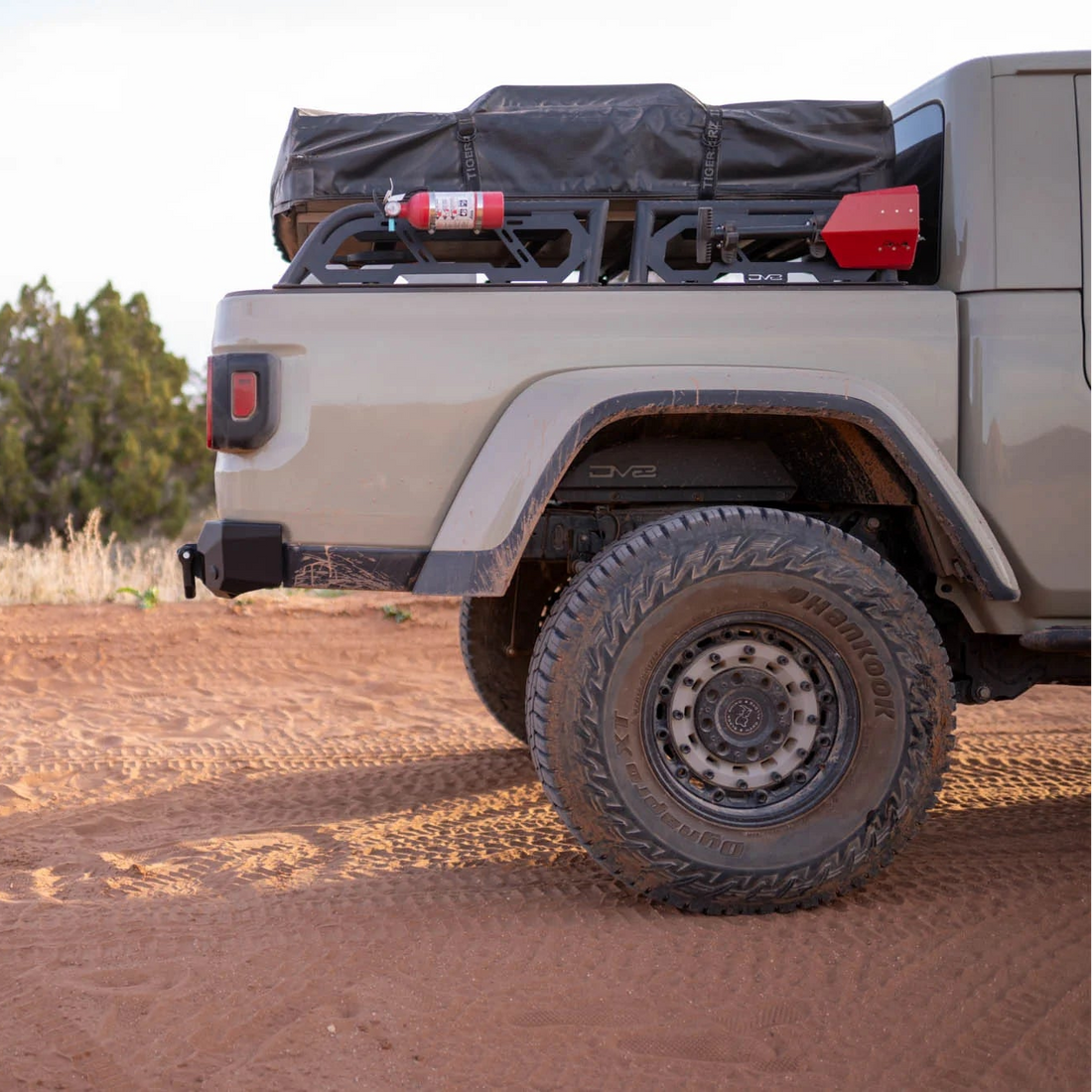 Off-road vehicle with a roof rack and cargo on a dirt road