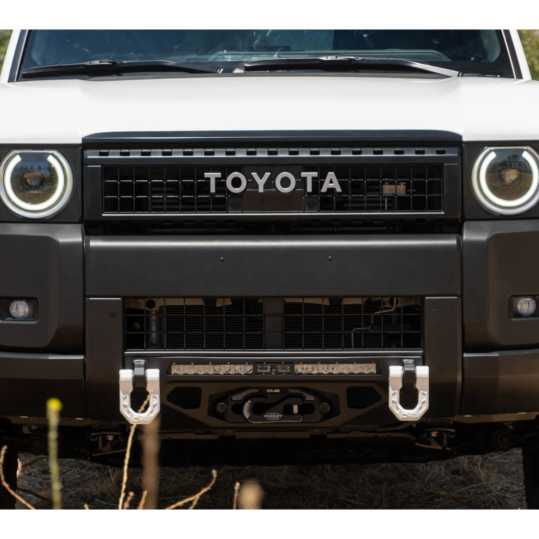 Front view of a white Toyota vehicle with a black grille and bumper.