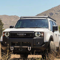 White Toyota SUV with roof rack in a natural setting