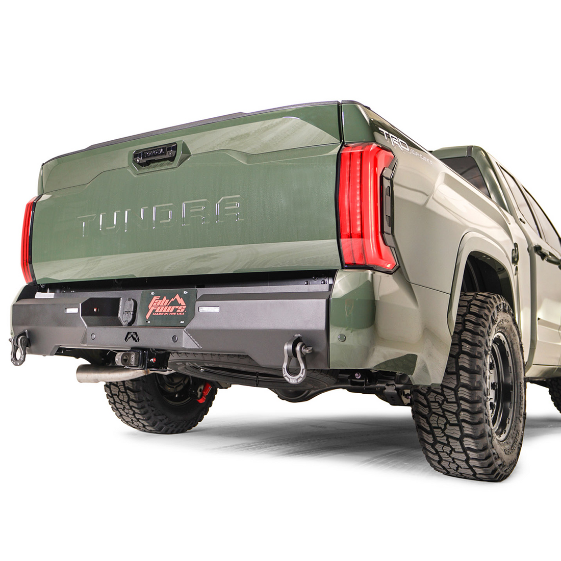 A black premium rear bumper for a Toyota Tundra pickup truck, featuring solid anchor points and recovery points.