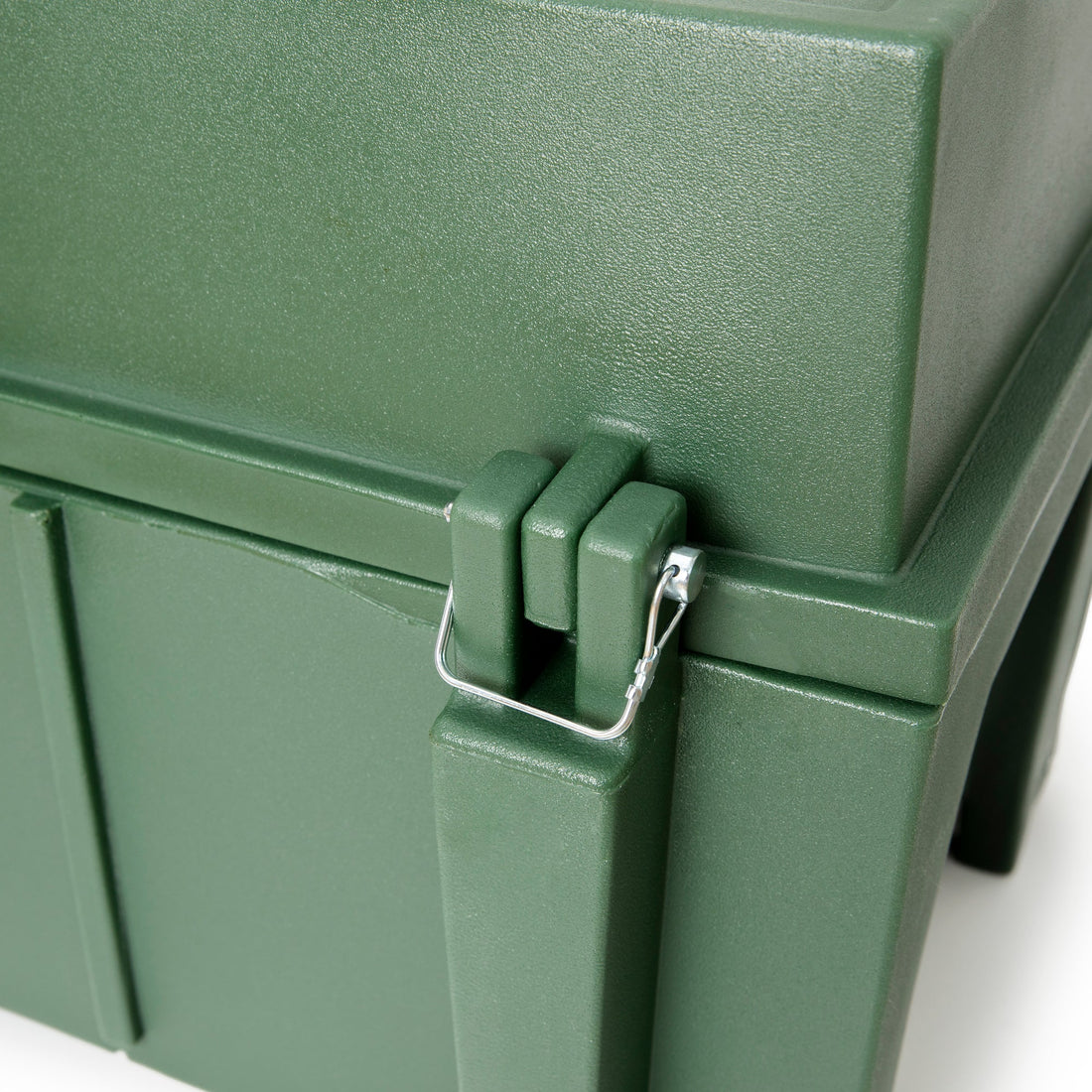 Close-up of a green metal box with a latch on a white background