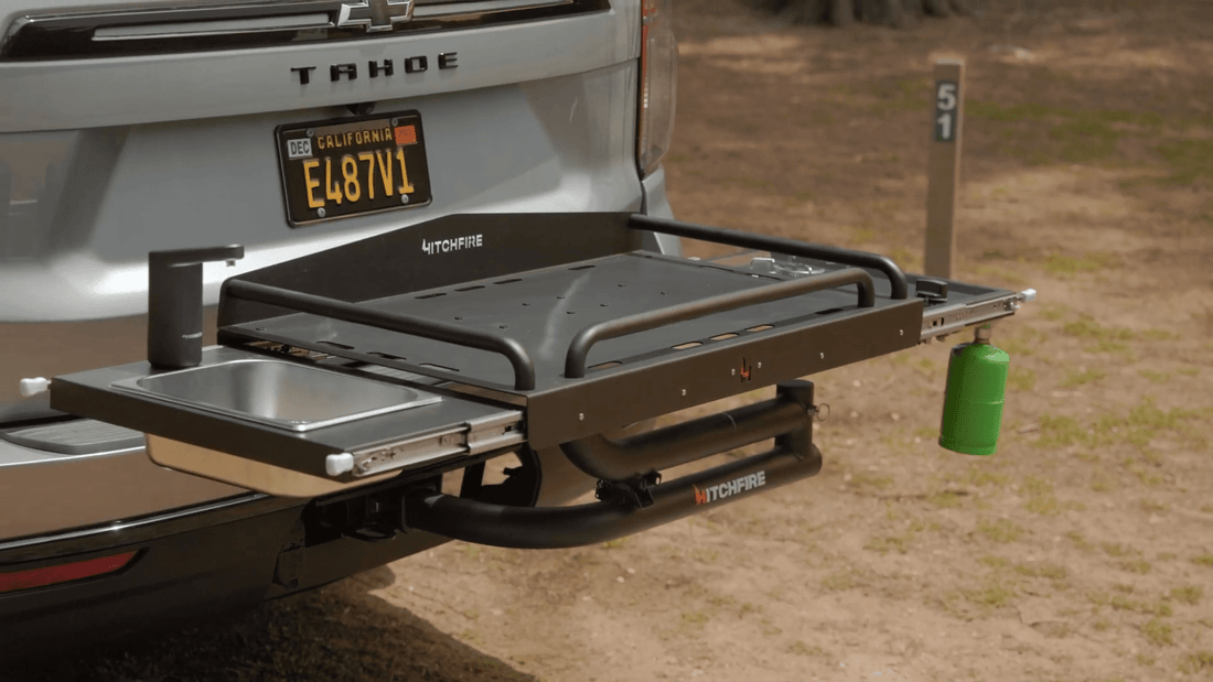Truck bed with an extended grill and sink setup on a natural background