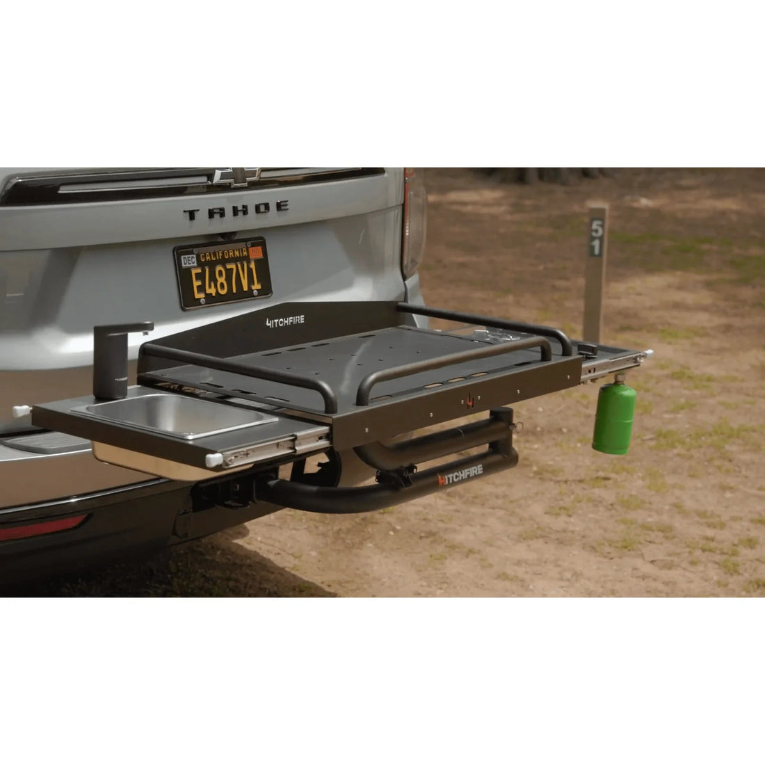Truck bed with an extended grill and sink setup on a natural background