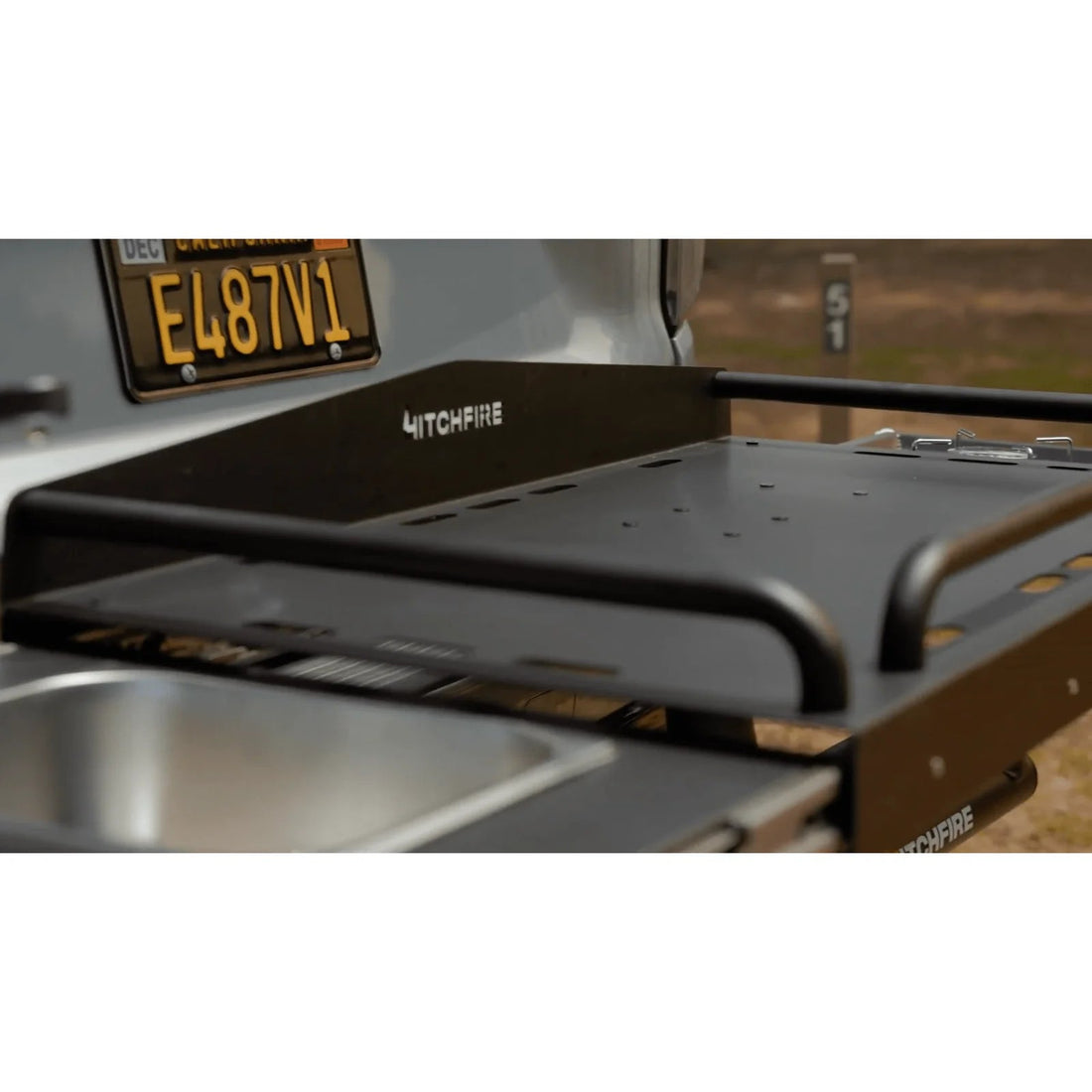 Black HitchFire vehicle accessory on a truck with a blurred background