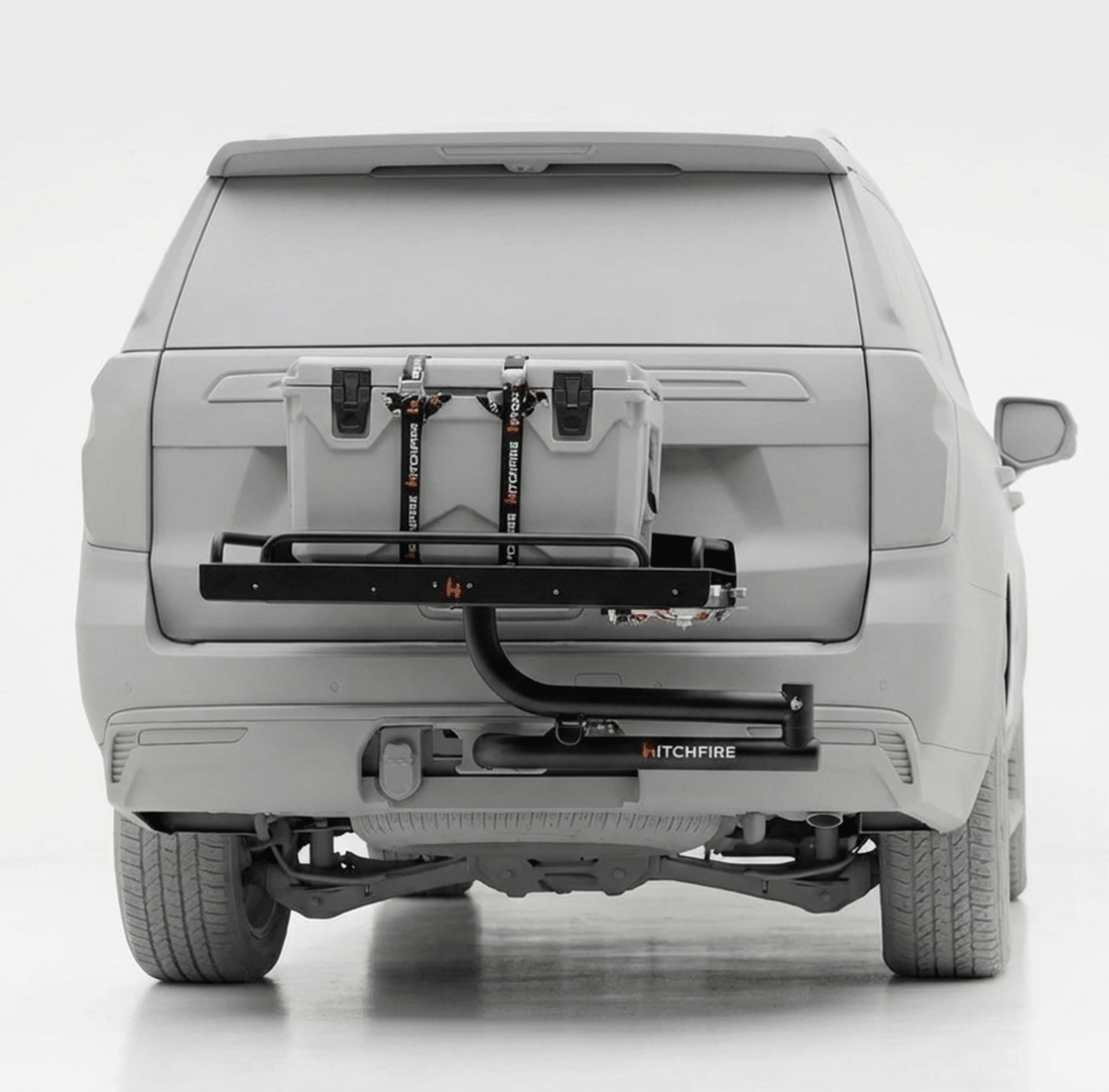 Car with a HitchFire bike rack attached to the back on a white background
