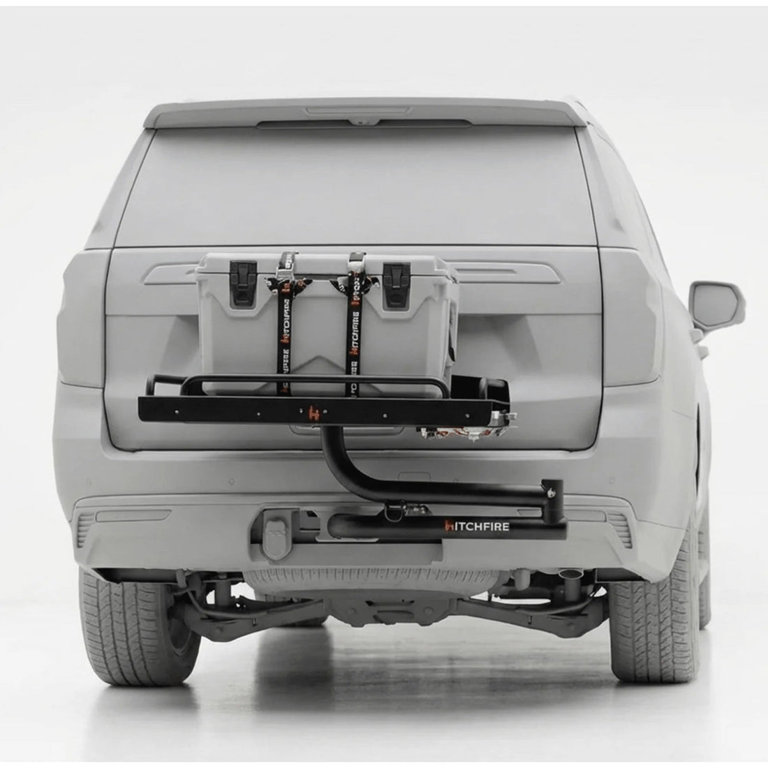 Car with a HitchFire bike rack attached to the back on a white background