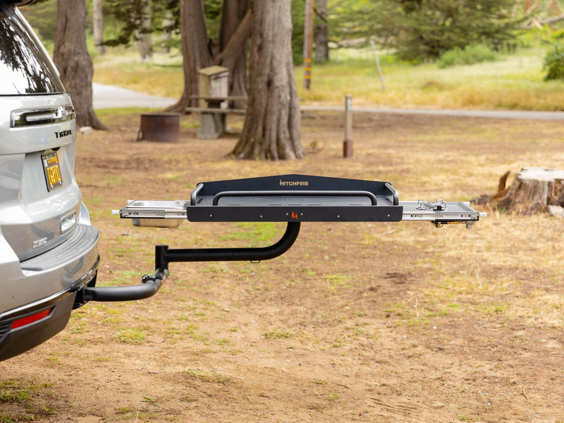 Tow bar attached to a vehicle in a natural setting with trees and grass.