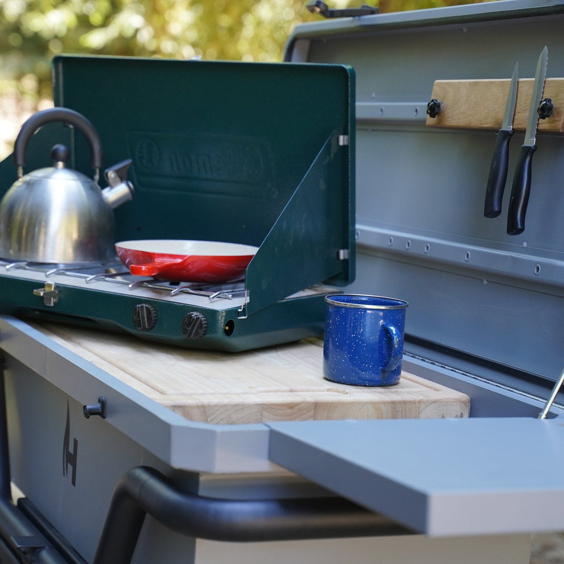 Camp stove with a kettle and pot on a camping vehicle&